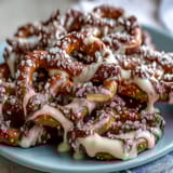 Festive St. Patricks Day Shamrock Pretzel Bites with white chocolate drizzle and green sprinkles for a sweet-salty holiday treat.