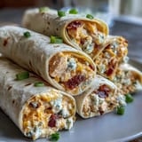 Zesty Buffalo Chicken Pinwheel Wraps featuring shredded chicken, spicy sauce, and cool cream cheese, sliced into colorful, easy-to-share bites.