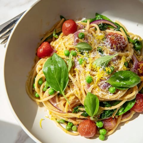Spring Veggie One-Pot Spaghetti with al dente pasta, peas, spinach, and cherry tomatoes simmered in vegetable broth.  