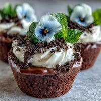 Mother's Day Flower Pot Brownies topped with creamy frosting and Oreo dirt.